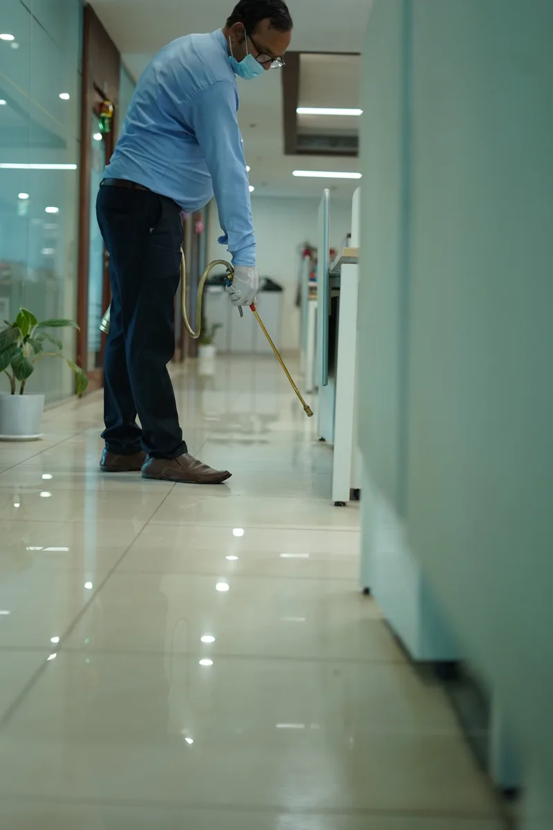 Field team of three with sprayers in an office