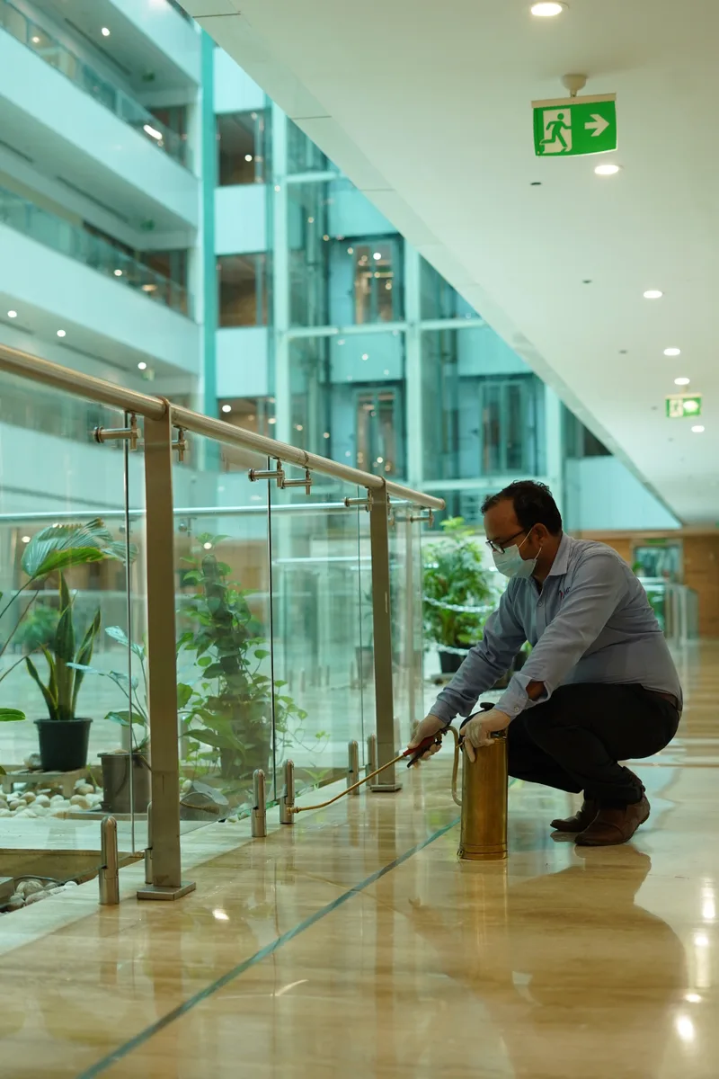 Technician working in a carpeted office bay